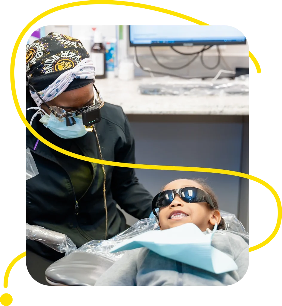 Dr. Drakeford performing a dental exam for child at For You Dental in Dallas, TX