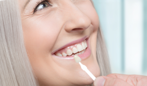 Woman smiling while receiving veneers at For You Dental in Dallas, TX