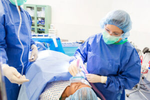 Dentist and team giving sedation to patient at For You Dental in Carrollton, TX